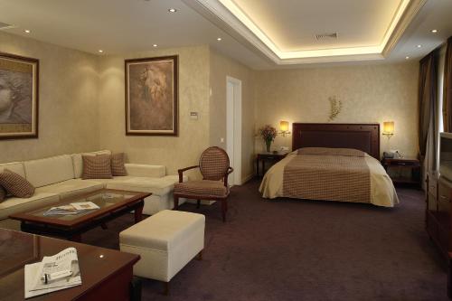a hotel room with a bed and a couch at Theoxenia House Hotel in Athens