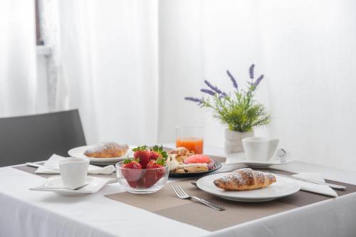 a table with plates of food and fruit on it at Irilor Luxury B&B in Valledoria