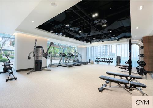 a gym with several treadmills and cardio machines at Amara Singapore in Singapore