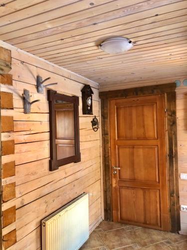 a room with a wooden wall and a door at "Будиночок гедоніста" in Tukhlya