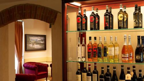 a bunch of bottles of wine on shelves in a room at Borgo Romantico Green Relais in Cavaion Veronese