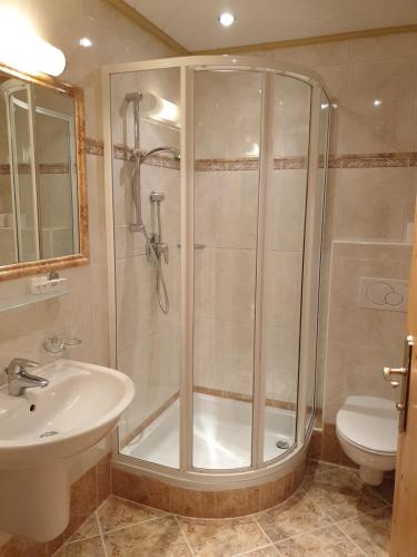 a bathroom with a shower and a sink at Berghotel Türlwand in Ramsau am Dachstein