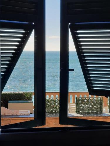 a view of the ocean from an open window at Romantic Sea View Flat in Genova in Genoa