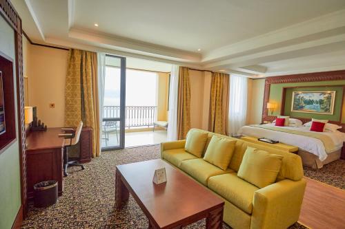 a hotel room with a couch and a bed at Goma Serena Hotel in Goma