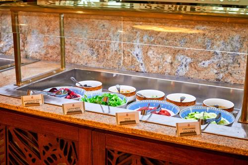 a buffet with different types of food on a counter at Goma Serena Hotel in Goma