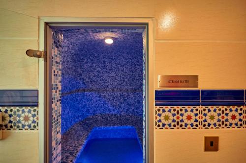 a bathroom with a blue shower with a blue tub at Goma Serena Hotel in Goma