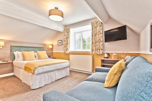 A bed or beds in a room at The Yewdale Inn and Hotel Coniston Village