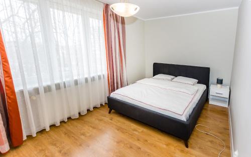 Giường trong phòng chung tại Apartament CZARNIECKIEGO