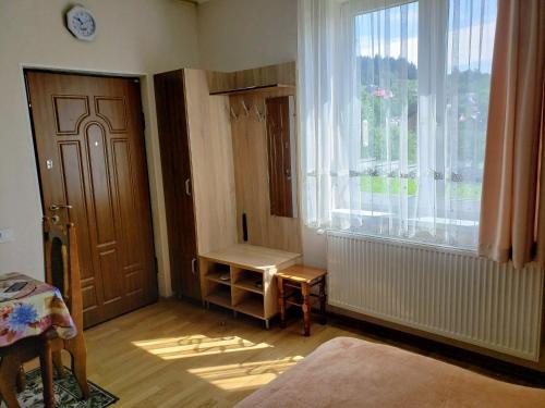 a living room with a door and a window at Апартаменти "Ілона" в центрі Східниці in Skhidnitsa