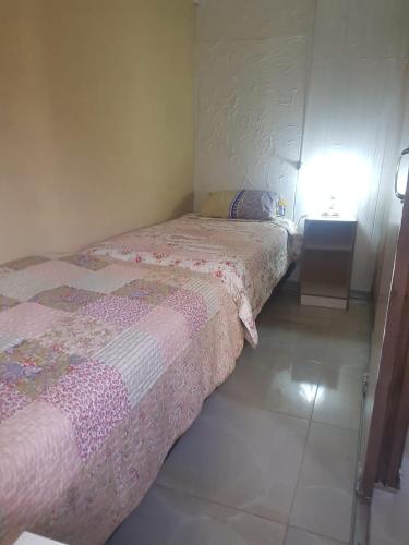 a small bedroom with two beds and a table at Anexo Golden in Cochabamba