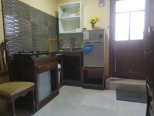 a kitchen with a stove and a sink and a refrigerator at Anexo Golden in Cochabamba