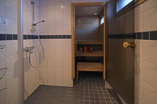 a bathroom with a walk in shower and a sink at Santa's Hotel Rakka in Kilpisjärvi