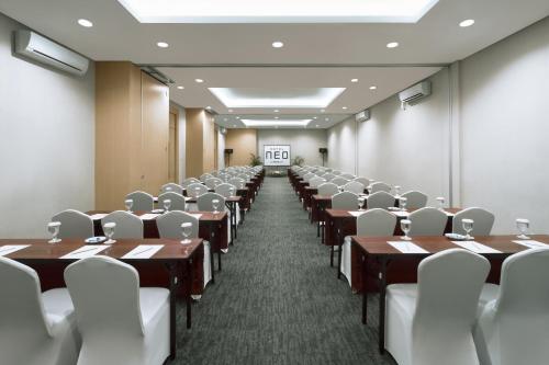 a conference room with tables and chairs in it at Hotel NEO Cirebon by ASTON in Cirebon