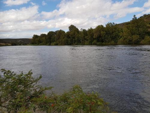 a large body of water with trees in the background at Oorvloed Guesthouse in Swellendam