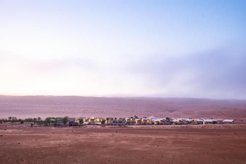 a group of houses in the middle of the desert at Arabian Nights Resort & Spa in Shāhiq