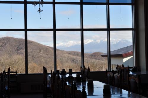 a table in a room with a view of mountains at Highland Furano in Furano