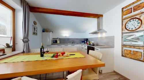 a kitchen with a wooden table and a dining room at AlpinDesign Kaunertal in Kaunertal