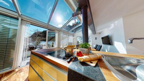 a kitchen with a counter with a sink and a window at AlpinDesign Kaunertal in Kaunertal