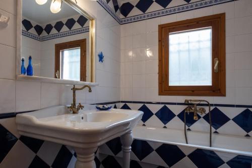 a bathroom with a sink and a bath tub at Villa Eirini with sea view in Dhriópi