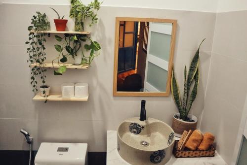 a bathroom with a sink and a mirror at Cube homestay Phan Rang cách biển 300m to the beach in Phan Rang