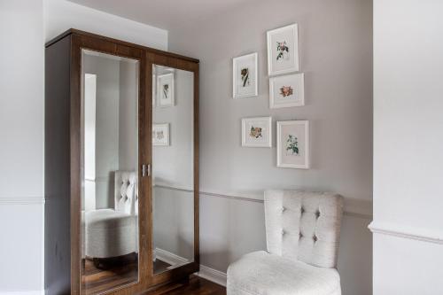 a mirror and a chair in a room at Millbrook Lodge in Ballynahinch