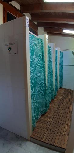 a row of stalls in a room with green walls at Alberg Rural La Rectoria de Pedra in Bellver de Cerdanya 