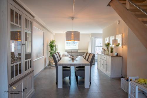 a kitchen and dining room with a table and chairs at Spacious apartment in the heart of Ostend near the sea in Ostend