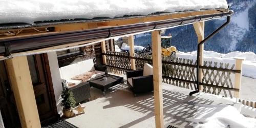 a balcony with snow on the roof of a house at Almliesl ZELL-448 in Zell am See