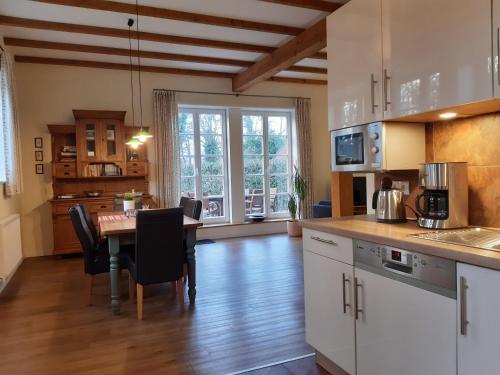 a kitchen and dining room with a table and chairs at Ferienwohnung Gänhauk 16 in Löningen