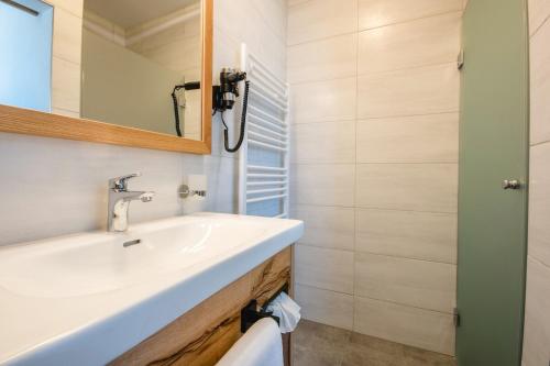 a bathroom with a sink and a mirror at Kopeindlgut Apartments in Wals