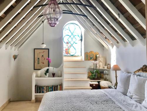 a bedroom with a bed and a stained glass window at HEAVEN PUERTA CERRADA Casas Vejer Debra in Vejer de la Frontera