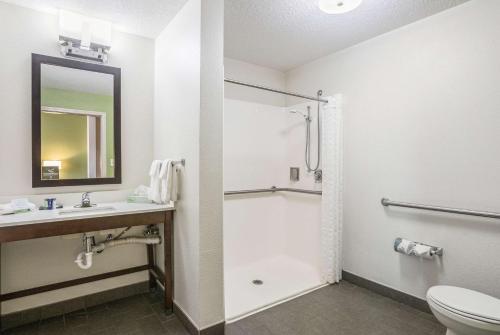a bathroom with a toilet and a sink and a shower at Sleep Inn & Suites Hiram - Atlanta Northwest in Hiram