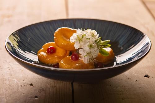 a bowl of fruit with a flower on top at Monverde - Wine Experience Hotel - by Unlock Hotels in Amarante