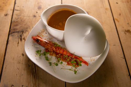 a plate with a shrimp and a cup of soup at Monverde - Wine Experience Hotel - by Unlock Hotels in Amarante