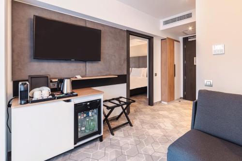 a hotel room with a flat screen tv on a wall at Holiday Inn Bucharest - Times by IHG in Bucharest