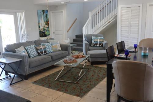 a living room with a couch and chairs and a table at Tranquility in Paradise - Sugarloaf - 17 miles to Key West in Sugarloaf Shores