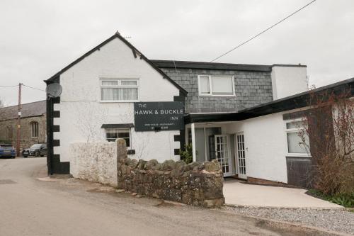 a building with a sign that reads the make break at The Hawk & Buckle Inn in Llannefydd