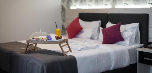 a bed with a tray of food on top of it at Hotel Fontana Vrnjačka Banja in Vrnjačka Banja