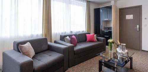 a living room with a couch and a table at Hotel Fontana Vrnjačka Banja in Vrnjačka Banja