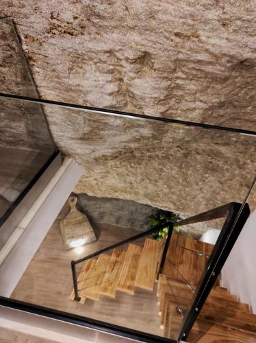 a glass floor with a staircase in a building at Casa cueva La Tosca in Setenil