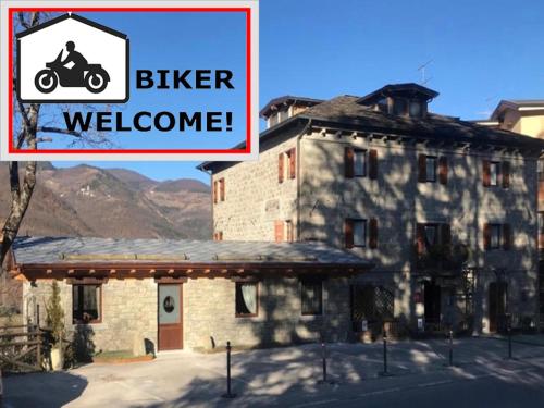 a building with a sign that reads bike welcome at Casa Benassi Rooms, Apartament & Suite con Piscina panoramica e Wellness in Riolunato