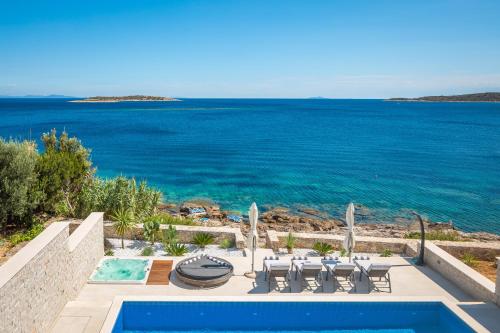 a swimming pool with a view of the ocean at Villa Carisma island Vis in Vis