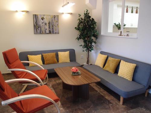 a living room with a couch and a table at Penzion Cabák in Vrchlabí