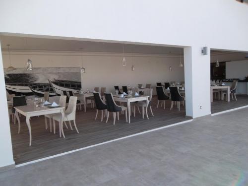 ein Esszimmer mit weißen Tischen und Stühlen in der Unterkunft Casa Lhana in Santa Maria