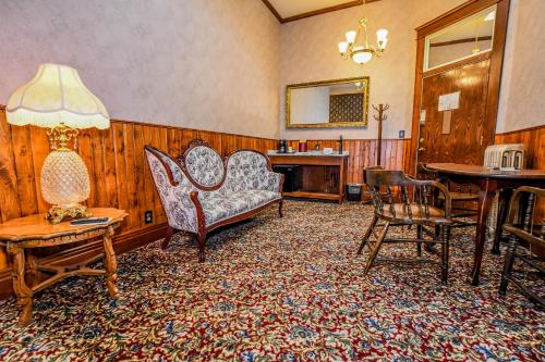 a living room with chairs and a table and a lamp at Irma Hotel in Cody