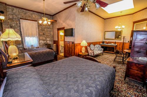 a bedroom with two beds and a television in a room at Irma Hotel in Cody