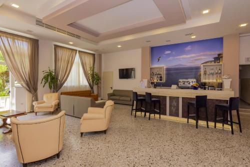 a living room with a large painting on the wall at Sisters Hostel in Piano di Sorrento