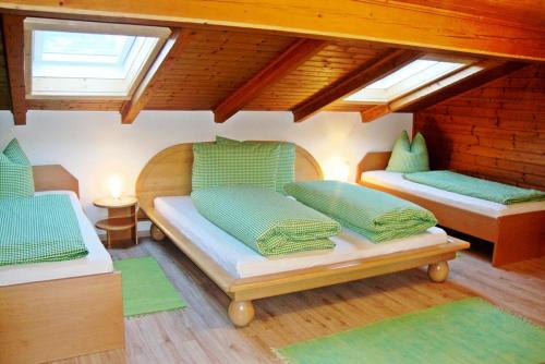 two beds in a room with two windows at Neubauhof in Reith im Alpbachtal