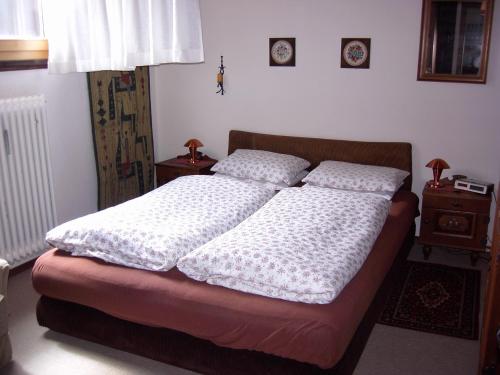 a bed with two pillows on it in a bedroom at Feichtenhof in Siegsdorf