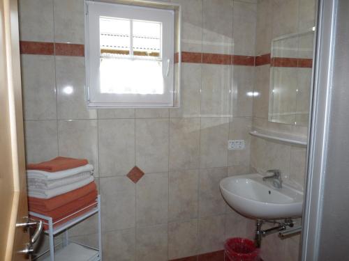 a bathroom with a sink and a window at Urlaub am Bauernhof Rothof in Sankt Johann im Pongau